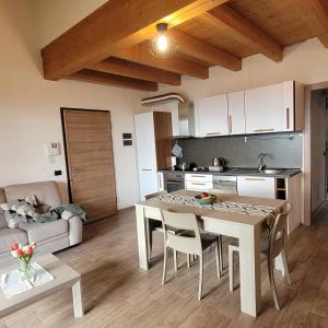 a kitchen and living room with a table and chairs at Casa Gioia Alpina Mountain Lake Iseo Hospitality in Bossico +21 photos