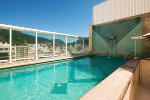 a swimming pool on the roof of a building at Hotel Bandeirantes in Rio de Janeiro