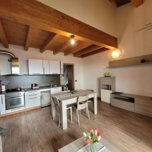 a kitchen with a table and chairs in a room at Casa Gioia Alpina Mountain Lake Iseo Hospitality in Bossico