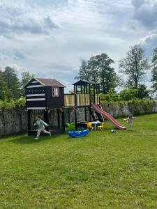 a group of children playing on a playground at Domki na Mazurach "Malinka" in Suchy Róg