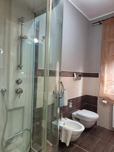 a bathroom with a glass shower and a toilet at Casa Letizia in Lercara Friddi +27 photos