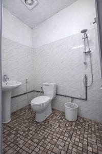 a bathroom with a toilet and a sink at Furnished Studio - Cite Progres in Djibouti