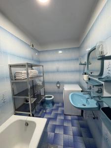 a blue tiled bathroom with a sink and a toilet at Apartman Seven Kaštel Stari in Kaštela +20 photos