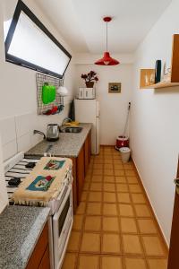 a small kitchen with a stove and a refrigerator at Departamento Centrico in Salta