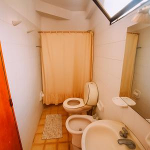 a small bathroom with a toilet and a sink at Departamento Centrico in Salta