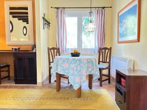 a dining room with a table and chairs and a window at Cas Quinto in Cala Ratjada +23 photos