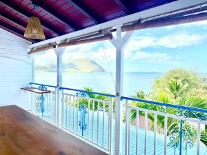a balcony with a view of the ocean at Sunset View - Panoramic Sea View - Deshaies in Deshaies