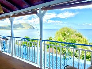 a view of the ocean from the balcony of a resort at Sunset View - Panoramic Sea View - Deshaies in Deshaies +14 photos