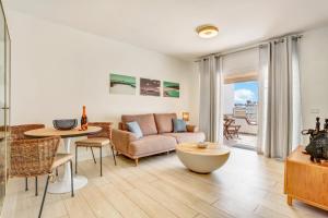 a living room with a couch and a table at Silvic Serenada in Corralejo
