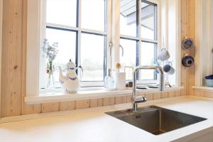 a kitchen with a sink and a window at 17716-Horve-Strandlunden-60 in Hørve +25 photos