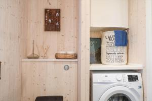a laundry room with a washing machine on a shelf at 17716-Horve-Strandlunden-60 in Hørve