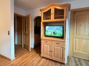 a large wooden entertainment center with a flat screen tv at Ferienwohnung Gipfeltraum in Berchtesgaden