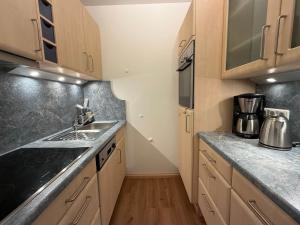 a small kitchen with a sink and a counter at Ferienwohnung Gipfeltraum in Berchtesgaden