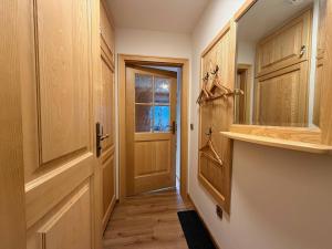 a hallway with wooden cabinets and a door at Ferienwohnung Gipfeltraum in Berchtesgaden +6 photos