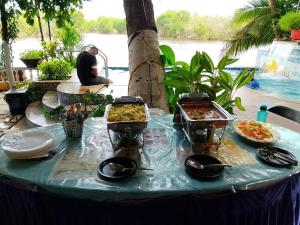 a table with several dishes of food on it at Serene Waters Homestay Goa in Panaji