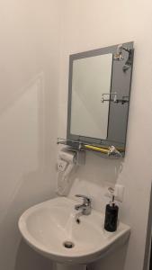a bathroom with a sink and a mirror on the wall at Xhoen guesthouse in Shkodër