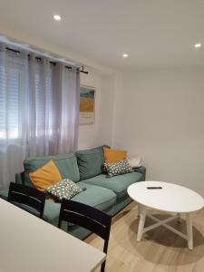 a living room with a couch and a table at Pretodomar3 in A Coruña