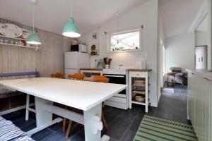 a kitchen with a large white table and chairs at 13360-1-Asnaes-Mejsevej-6 in Asnæs +7 photos