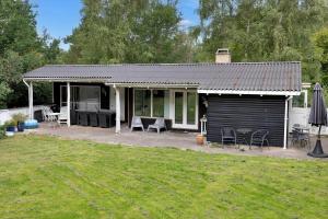 a small house with a patio and a garage at 13360-1-Asnaes-Mejsevej-6 in Asnæs