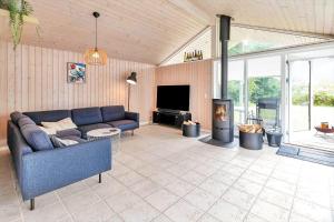 a living room with a couch and a fireplace at 14233-Grevinge-Grevinge-Kanalvej-95 in Grevinge