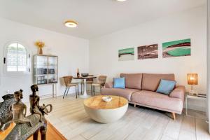 a living room with a couch and a table at Silvic Serenada in Corralejo