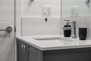a kitchen counter with a sink in a bathroom at Stylish Serenity 1BR Kensington Condo wParking in Calgary +33 photos