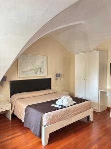 a bedroom with a large bed in a room at Faro Bianco Gallipoli - Suites & Apartments in Gallipoli