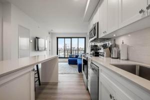 a kitchen with a sink and a counter top at Exquisite 2 Bed Condo near DT Core WFree Parking in Calgary