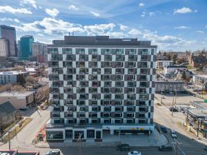 an aerial view of a large building in a city at Exquisite 2 Bed Condo near DT Core WFree Parking in Calgary