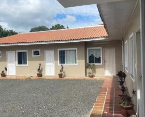 a house with an orange roof at Pousada 4 Estações in Canoinhas