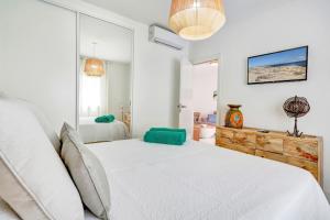 a white bedroom with a large bed and a window at Silvic Serenada in Corralejo +22 photos