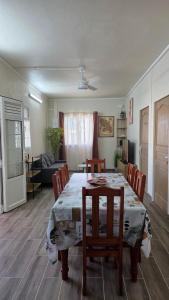 a dining room table and chairs in a room at Villa Maxime in Sainte-Marie