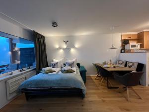 a bedroom with a bed and a dining table at Bergidylle Simonhöhe, Kärnten in Zirkitz +39 photos