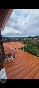 a wooden deck with a bench on top of a house at Chales praias de Ubatuba in Ubatuba