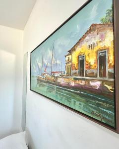 a painting of a painting of a boat on a wall at Quarto 02 - Pousada Canaã in Recife