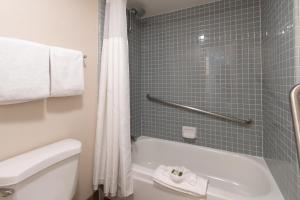 a bathroom with a tub and a toilet and a shower at San Clemente Cove Resort in San Clemente +36 photos