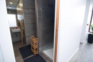 a bathroom with a shower with a glass door at Hostel D'Avenida in Vila Praia de Âncora +37 photos