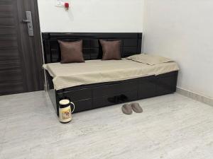 a bed in a room with a coffee cup on the floor at Bliss in Datia