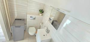 ein kleines Badezimmer mit Toilette und Waschbecken in der Unterkunft Zakątek w Centrum Suwałk in Suwałki