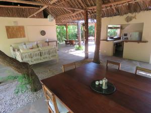 a dining room with a table and a couch at 1, 2 bed bungalow Watamu in Watamu
