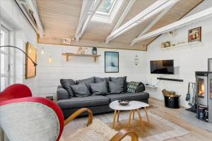 a living room with a couch and a fireplace at LF722-Hurup-Thy-Haettemagevej-22 in Sindrup