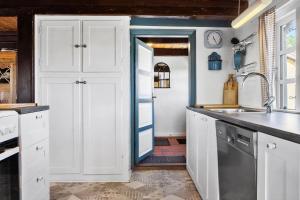 a kitchen with white cabinets and a sink at LF10304-Hurup-Thy-Gundtoft-Mollevej-4 in Gettrup