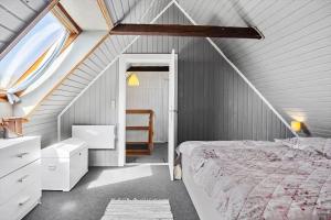 a attic bedroom with a bed and a window at LF10304-Hurup-Thy-Gundtoft-Mollevej-4 in Gettrup +15 photos