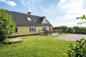 a house with a picnic table in the yard at LF10304-Hurup-Thy-Gundtoft-Mollevej-4 in Gettrup