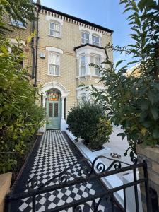 a house with a gate in front of it at Stockwell Residences - The Eclipse Room in London