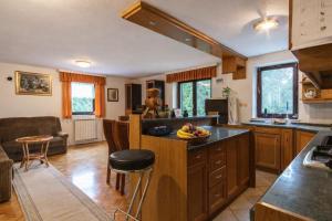 a kitchen with a island with a bowl of fruit on it at Apartment Satya in Dobrna