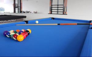 a blue pool table with balls and a cue at Hotel Asturias in Girardot
