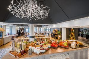 a buffet of food in a restaurant with a chandelier at Budapest Museum Central in Budapest