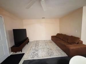 a living room with a couch and a flat screen tv at Townhouse 2 bed 2 bath neat and comfy in Gainesville
