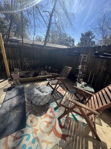 a backyard with two chairs and a fence at Townhouse 2 bed 2 bath neat and comfy in Gainesville